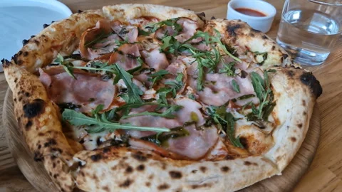 Appetizing pizza on a table in a cafe. Stock Footage 241087636
