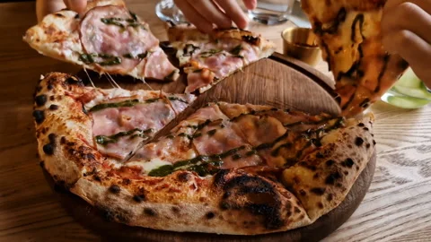 Appetizing pizza on a table in a cafe. Stock Footage 241215583