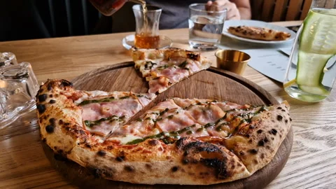 Appetizing pizza on a table in a cafe. Stock Footage 241326982