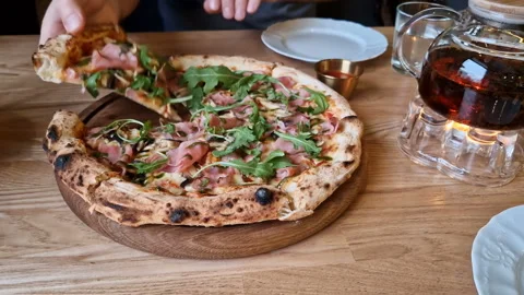 Appetizing pizza on a table in a cafe. Stock Footage 241327701