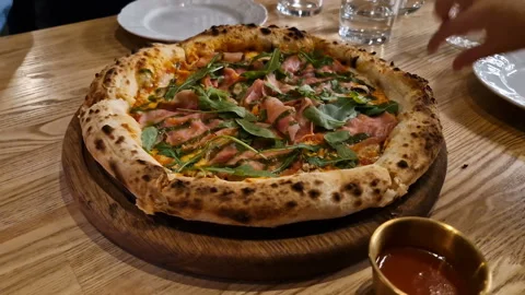 Appetizing pizza on a table in a cafe. Stock Footage 241563070