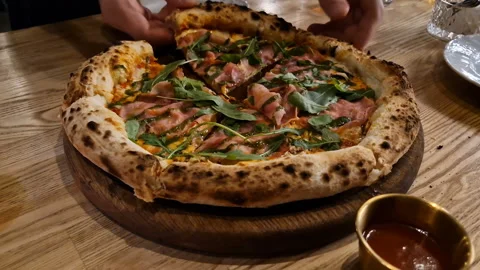 Appetizing pizza on a table in a cafe. Stock Footage 241658883