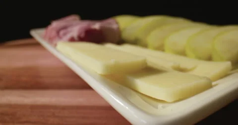 Appetizing plate of cheese, prosciutto, and apple slices. Stock Footage 130697418