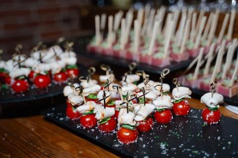 Appetizing platter of cherry tomatoes topped with cheese and herbs Stock Photos