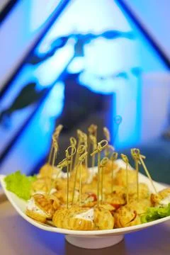 Appetizing platter of savory bite-sized snacks with decorative skewers Stock Photos