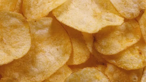 Appetizing potato chips rotating in 4K. Super closeup flat-lay view 動画素材 89891468