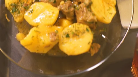 Appetizing potatoes and stewed meat on plate for lunch in cafe close up Stock Footage 90676770