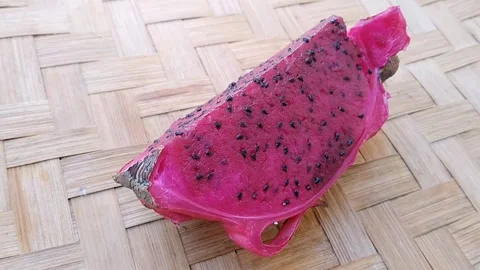 Appetizing Quartered Dragon Fruit Pieces on Woven Bamboo Mat Video stock 343341149