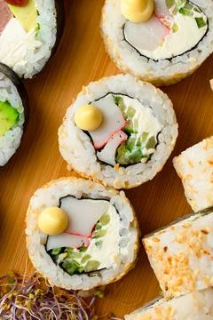 Appetizing roll with Philadelphia cheese, crab stick, cucumber and microgreen on Stock Photos