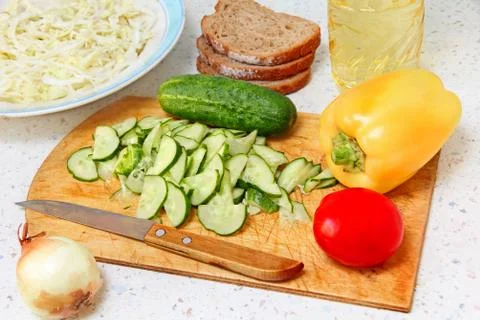 Appetizing salad ingredients on kitchen table. Stock Photos