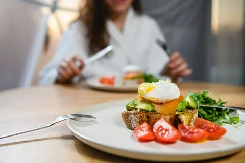 Appetizing sandwich with poached egg on the table. Stock Photos