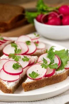 Appetizing sandwiches of rye bread with curd cheese, radishes and lettuce. Ru Stock Photos