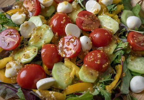 Appetizing sauce in vegetable salad. Stock Photos
