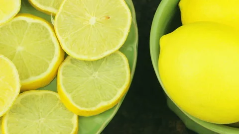 Appetizing Set Of Ripe Lemons And Slices Rotating. Seamless Looped Composition Stock Footage 114915067