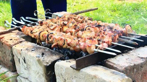 Appetizing shashlik outside. Process of cooking meat. Barbecue lunch Stock Photos