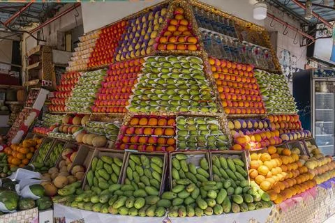 Appetizing showcase of the fruit store with many boxes of mango, oranges, pom Stock Photos