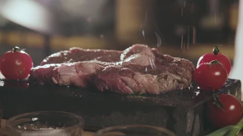 Appetizing slice of Meat with Fresh Tomatoes Cooked on the Hot Stone.  Video stock 91043497