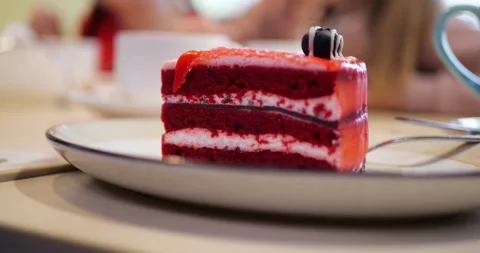 Appetizing slice of red layered cake on elegant porcelain plate Stock Footage 308451384