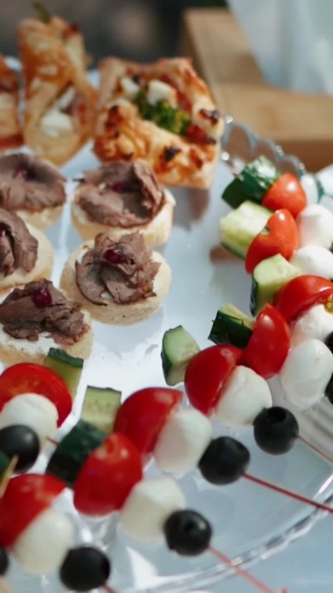 Appetizing slices of different types of cheese and meat a festive banquet table Stock Footage 325719280