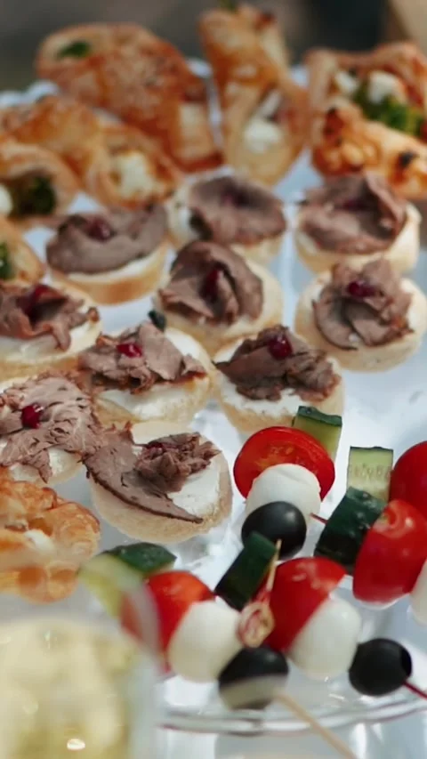 Appetizing slices of different types of cheese and meat a festive banquet table Stock Footage 325719282