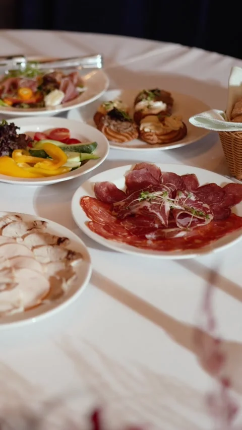 Appetizing slices of different types of cheese and meat a festive banquet table Stock Footage 325986150