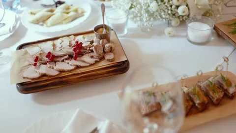 Appetizing slices of different types of cheese and meat a festive banquet table Stock Footage 326325749