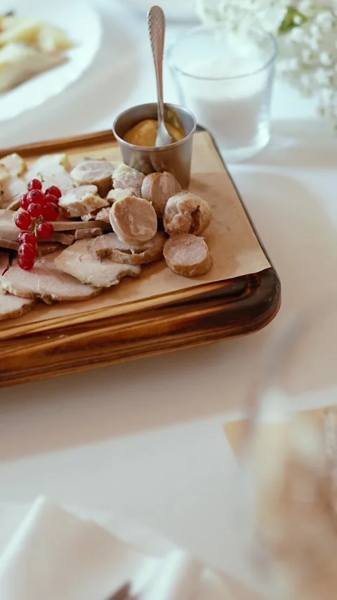 Appetizing slices of different types of cheese and meat a festive banquet table Stock Footage 326470799