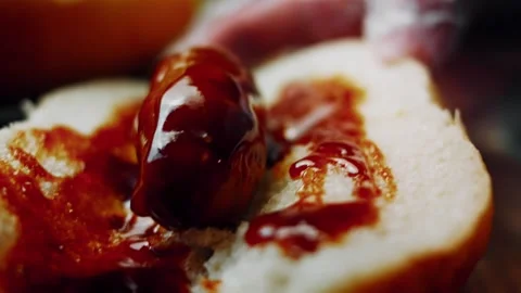 Appetizing soft bread surrounding a browned frankfurter in low angle, 4K Stock Footage 341116693