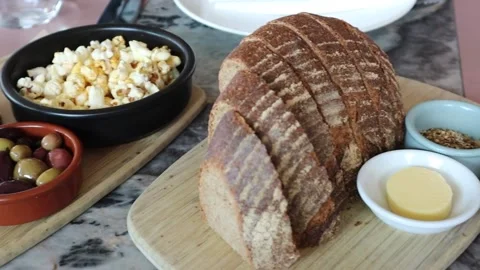 Appetizing starters bread olives and butter popcorn served Stock Footage 228408238