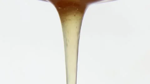 An appetizing stream of honey flows smoothly and continuously. Asmr. Stock Footage 281666683