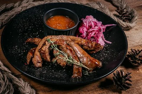 Appetizing Strips of Grilled Beef with Vibrant Sauce and Pickled Onions on .. Stock Photos
