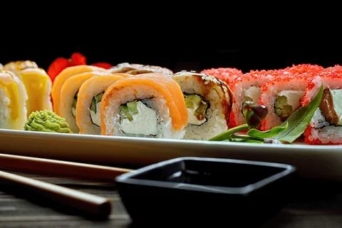 Appetizing sushi rolls in assortment. Soy sauce, ginger. Close up Stock Photos