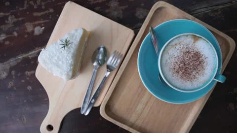 Appetizing sweet piece of cake and cup of cappuccino. slow motion Stock-Footage 233771946