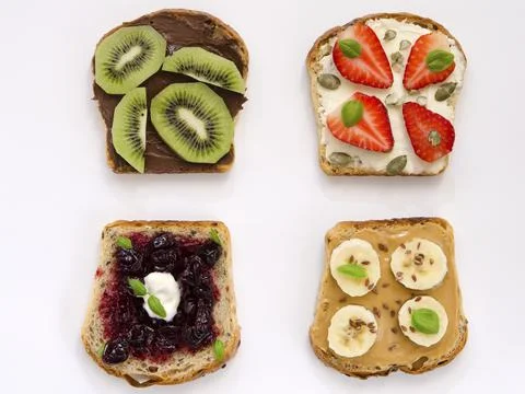 Appetizing sweet toasts with fruit on a white background Stock Photos