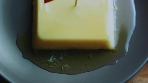 Appetizing tabletop study of lifting a bite from the square flan Stock Footage 342154155