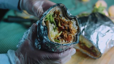 Appetizing tabletop view: close view of a layered burrito filling Stock Footage 342168501