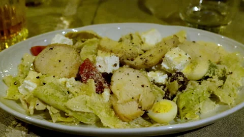 An appetizing variation of Caesar salad with chicken on a flat round plate Stock Footage 303472037