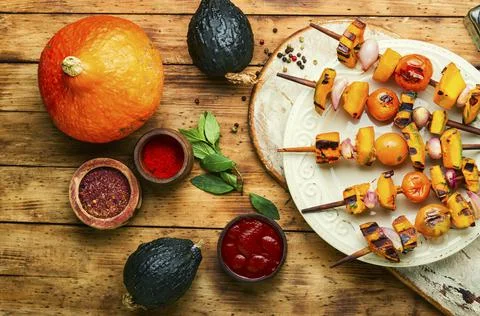 Appetizing vegetable kebab on wooden table Stock Photos