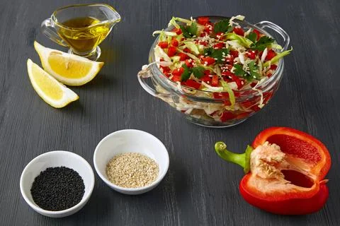 Appetizing vegetable salad of chopped cabbage and bell peppers with parsley and Stock Photos