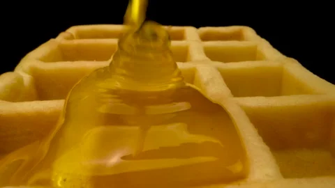 Appetizing waffle watered with honey close-up Stockbeeldmateriaal 159736673