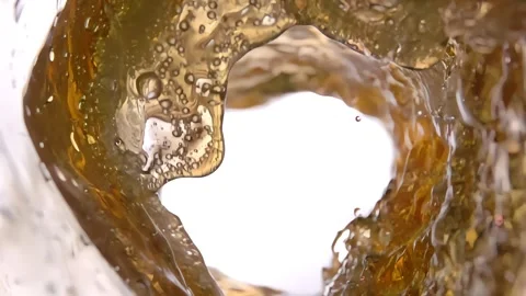 Appetizing wave of white grape juice swirls inside the glass Stock Footage 310624295