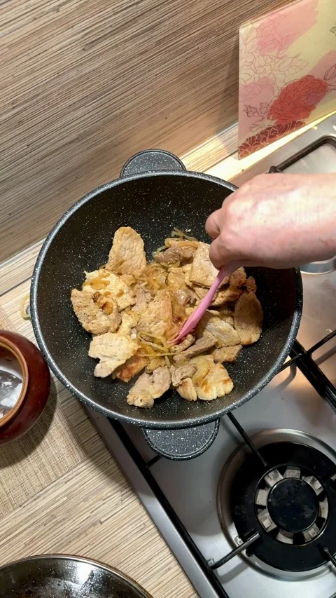 Appetizingly cooked chicken in a cast-iron cauldron is perfect for any dish Stock Footage 316344455