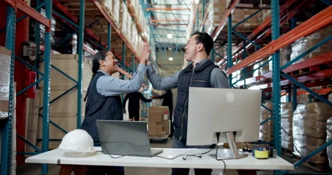 Applause, computer and high five with people in warehouse for distribution Stock Footage 335792107