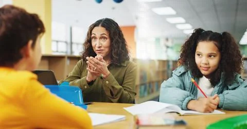 Applause, education or study with students and teacher in library of school for Stock Photos
