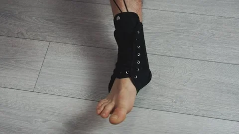 Applaying compression ankle stabilizer bandage. Leg injury and sprain of sports Stock Footage 172220432
