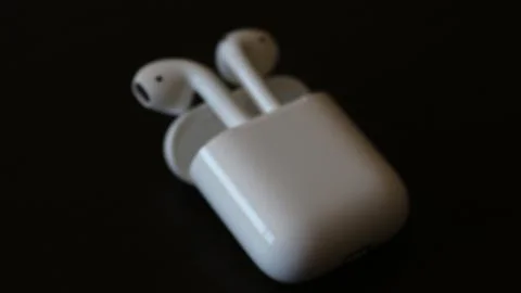 Apple Airpods Isolated On Black Background Stock Photos