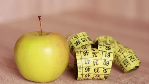 Apple and centimeter tape closeup Stock Footage 81584682