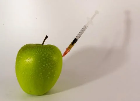 Apple and Hypodermic Syringe. Stock Photos