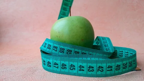 Apple and measuring tape Stock Footage 103834853