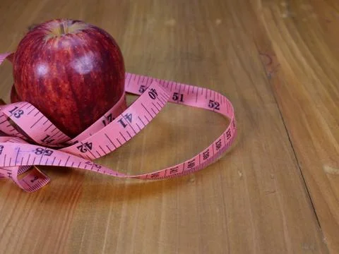 Apple and measuring tape Stock Photos